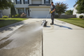 Residential driveway before and after professional power washing
